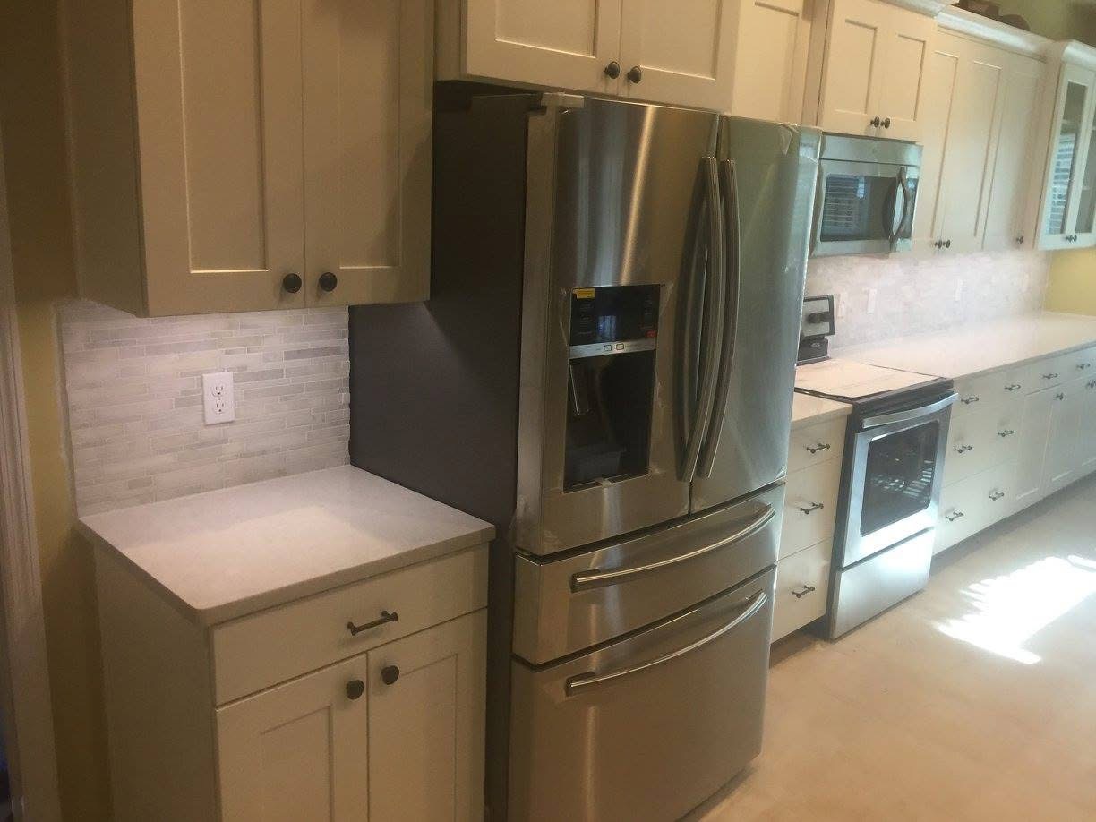 Detail of the finished cabinet run and marble mosaic tile backsplash