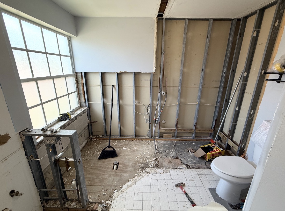 Same bathroom stripped to studs during demolition