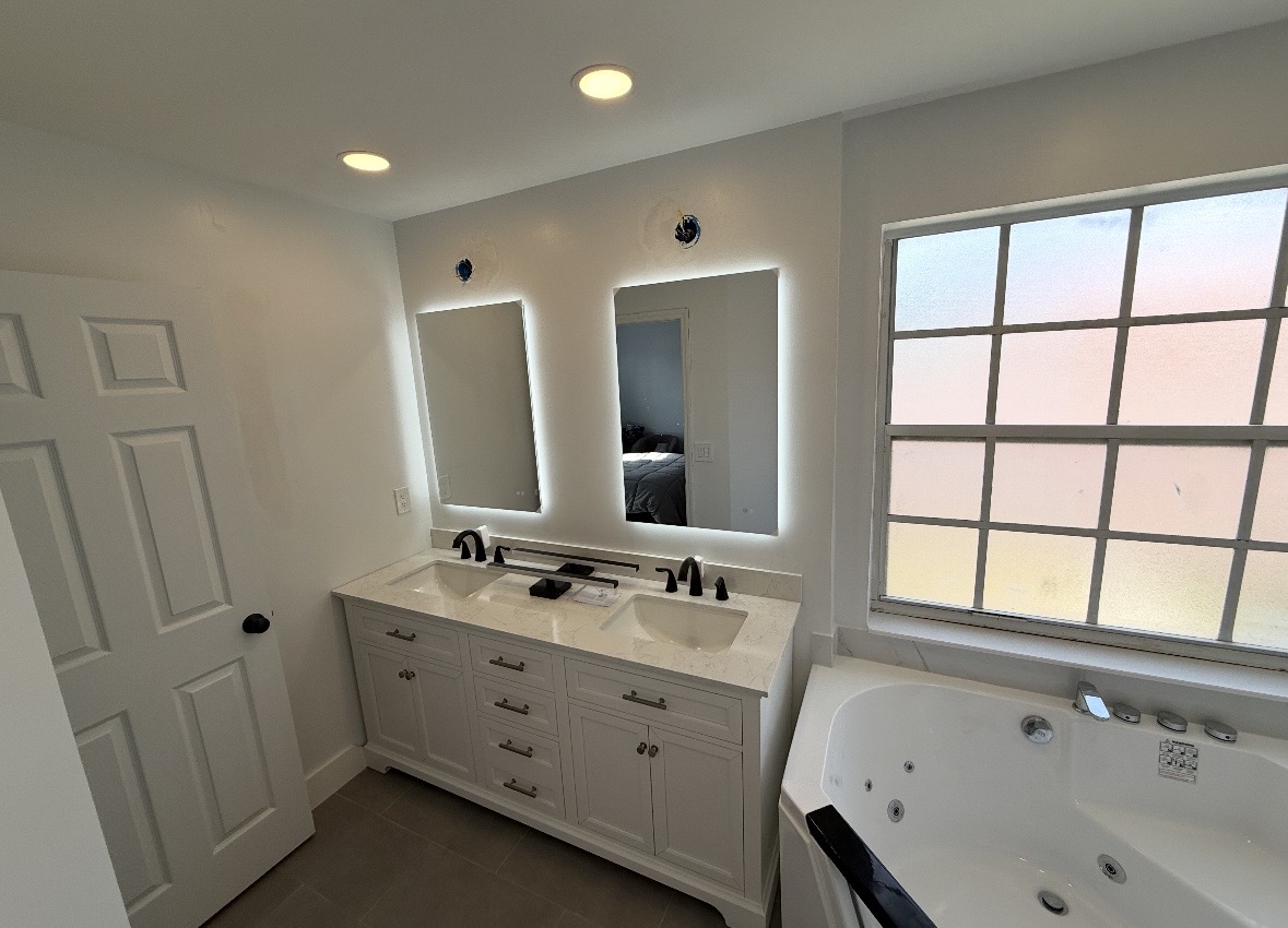 Double vanity with quartz top and backlit LED mirrors