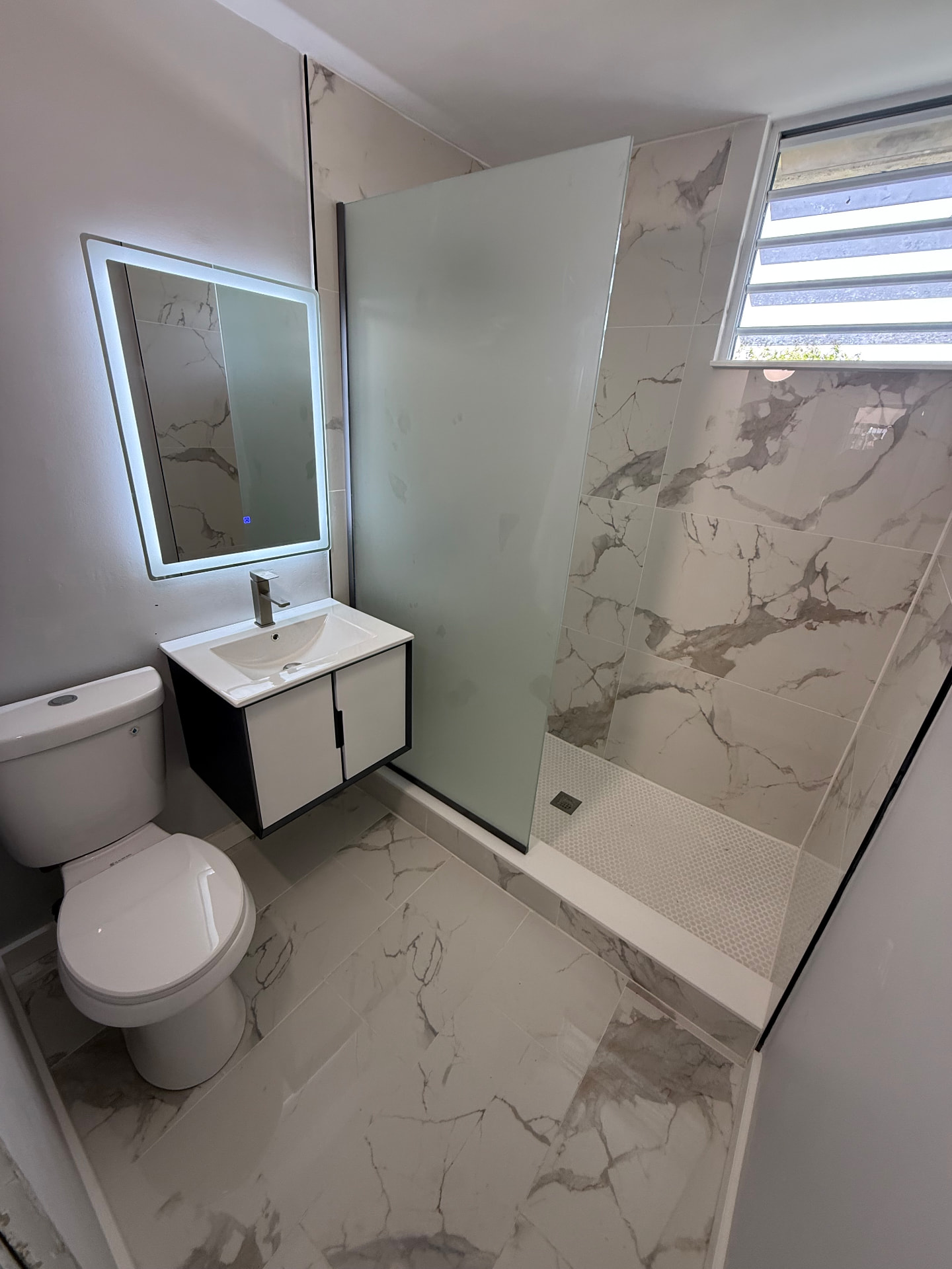 Guest bath with walk-in glass shower and floating vanity