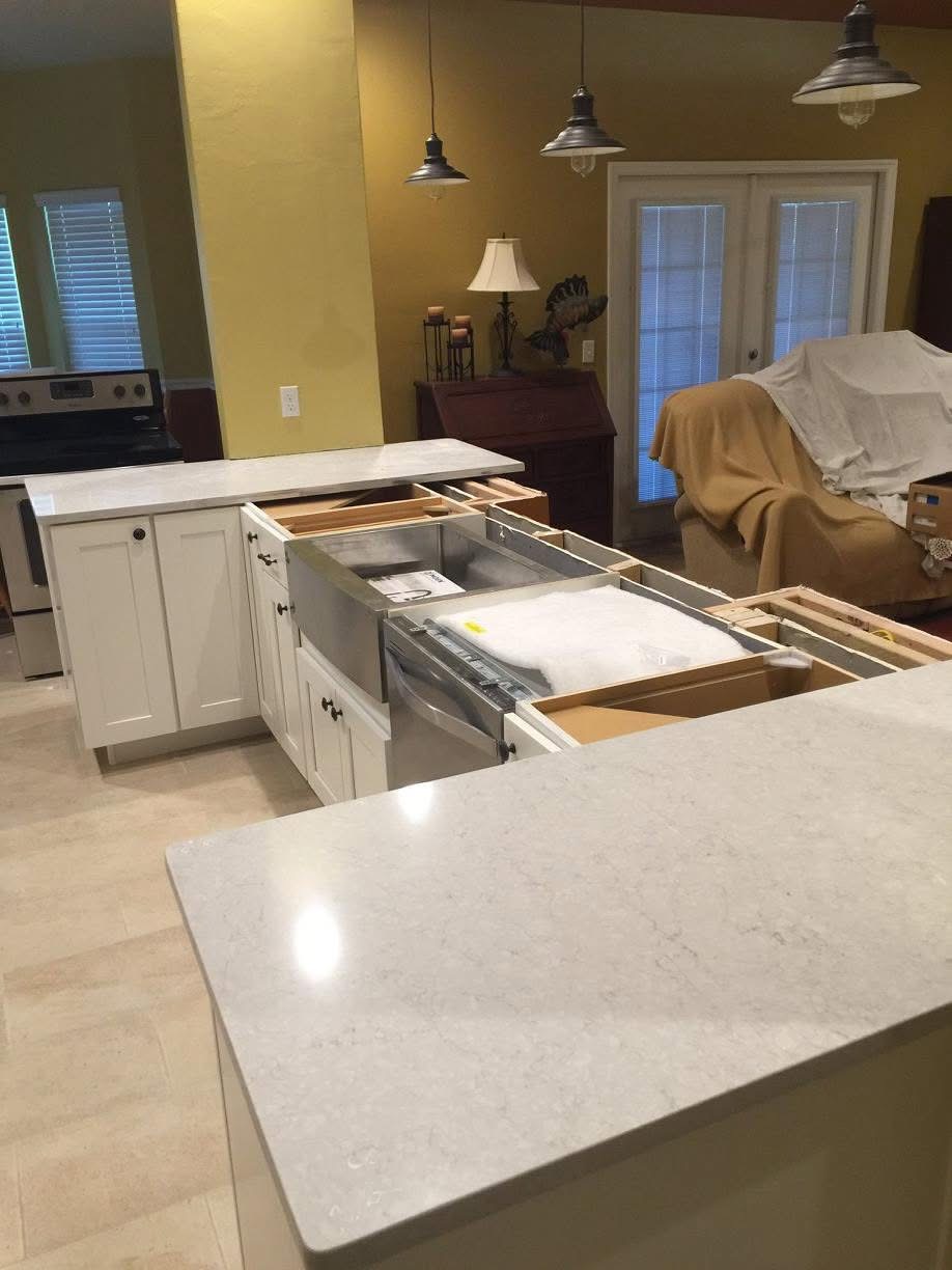 Quartz countertops installed over the island with farmhouse sink cutout